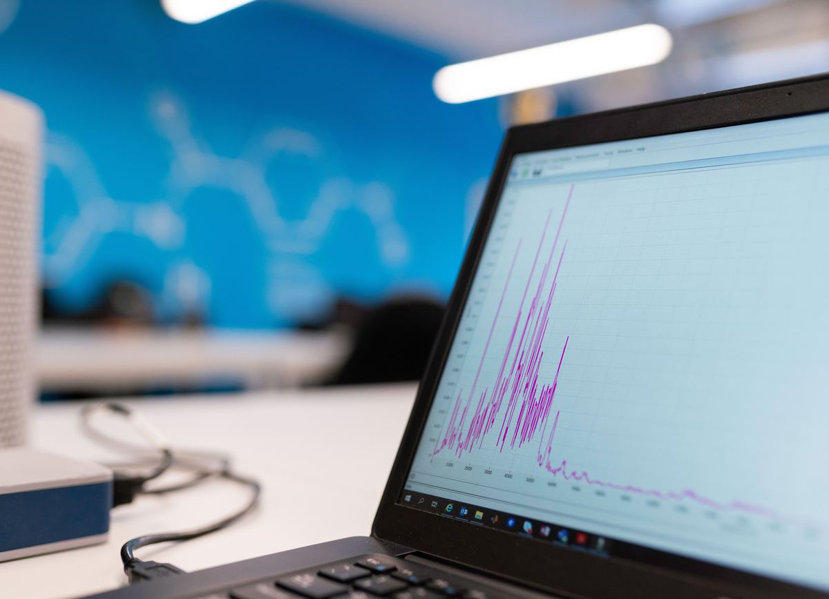 A laptop on a desk showing a line chart